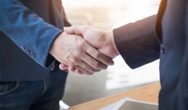 Two confident business man shaking hands during a meeting in the office, success, dealing, greeting and partner concept